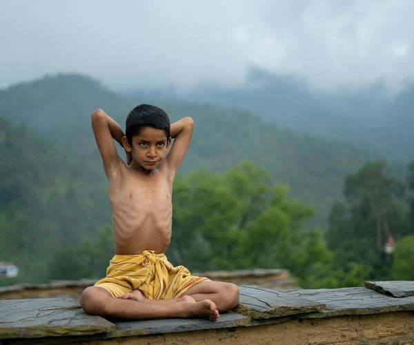 A calm and focused woman meditating in a lotus position.