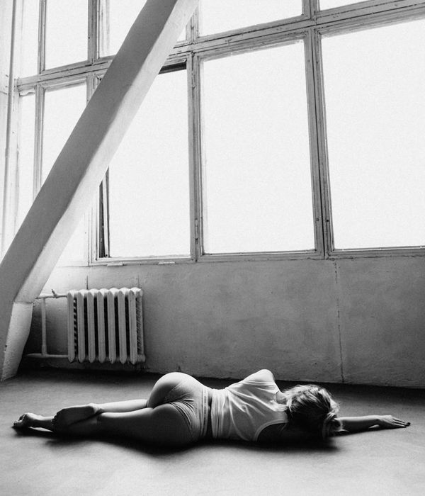 Woman in a peaceful yoga pose in a modern studio.